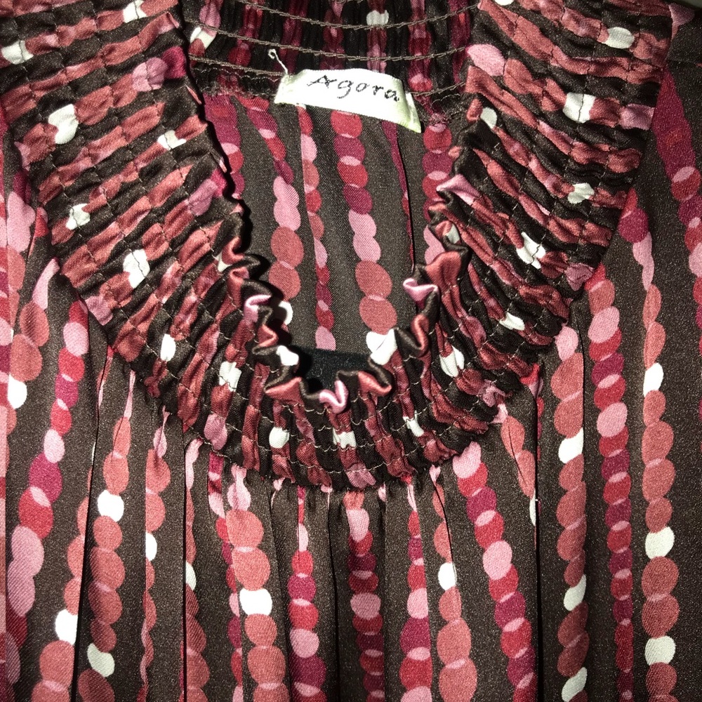 Super cute mock neck sleeveless ruffle hem top.
